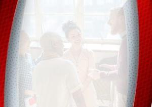 A hazy image of a diverse group of coworkers smiling and meeting together.